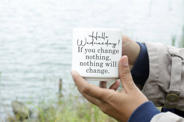 Wednesday quote - If you change nothing, nothing will change. White coffee cup in young woman hand with Wednesday motivational and inspirational quote - Hello Wednesday. If you change nothing, nothing will change. On blue sea water  background. wednesday morning stock pictures, royalty-free photos & images