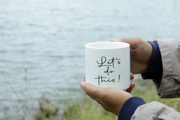 istock Let's do this. Positive notes and motivaitonal quote on coffee cup in hands. 1297146092