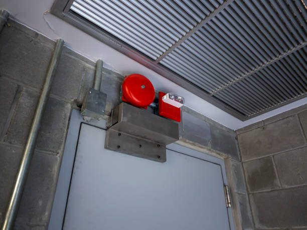 istock Electric red fire ring bell alarm on the wall in system room 1297146154
