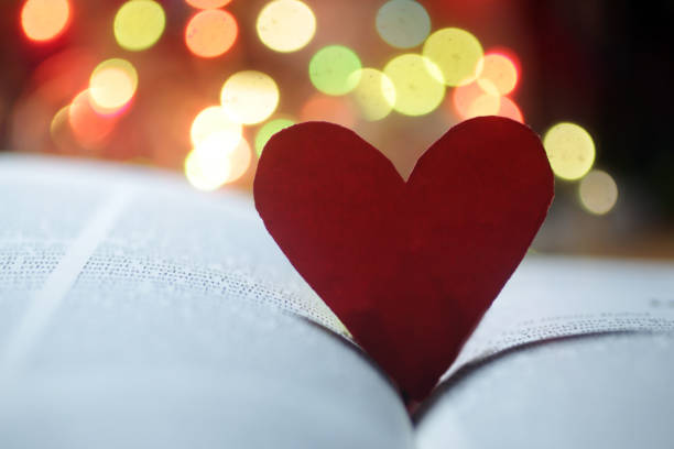 istock Red heart, a love shaped symbol on a book. 1297146818