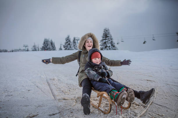istock Favorite winter fun with mum 1297147842