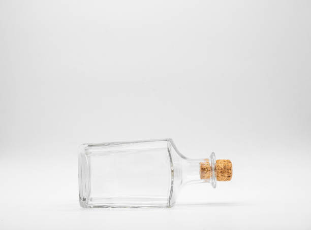 istock Empty glass bottle closed with cork cap isolated on a white background. 1297149899