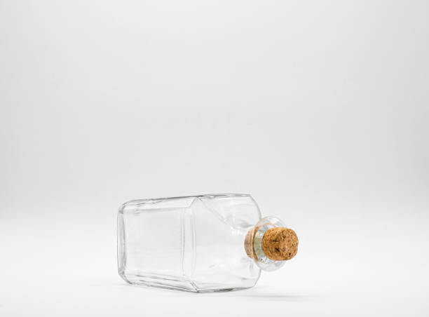 istock Empty glass bottle closed with cork cap isolated on a white background. 1297149904