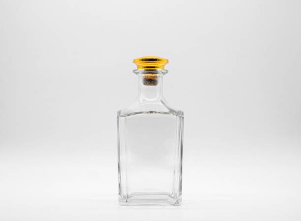 istock Empty glass bottle closed with big golden round cork isolated on a white background. 1297149941