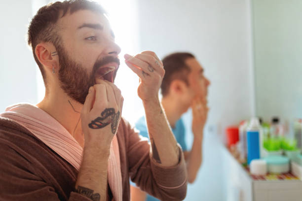 istock Cleaning teeth with dental floss 1297154772