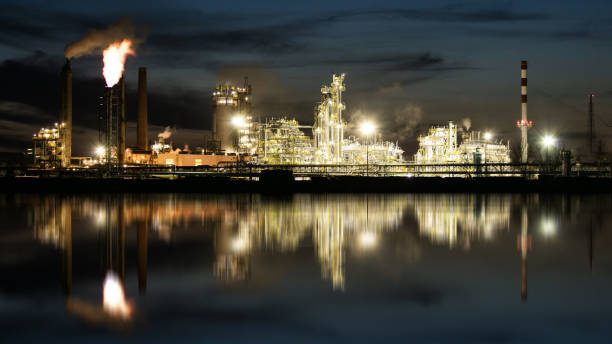 istock Factory with air pollution, Oil industry 1297155564