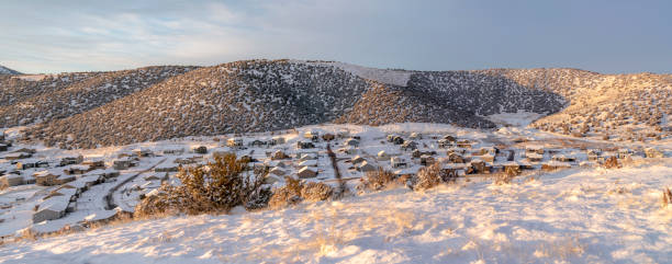 istock Houses amid hills covered with fresh winter snow under cloudy blue sky 1297156652