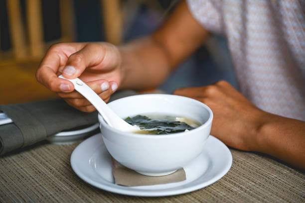 Unrecognizable woman eating fresh miso soup, Nikon Z7