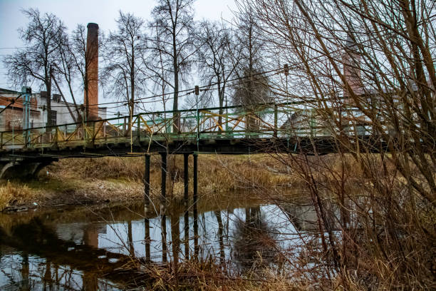 Old abandoned wooden bridge close up in winter, bottom view
