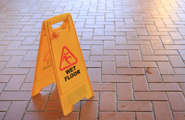 istock Beware of slippery floors. Caution wet floor warning 1297157913