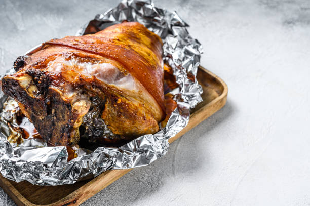 istock Roast pork knuckle with pepper and spices. Gray background. Top view. Copy space 1297158475