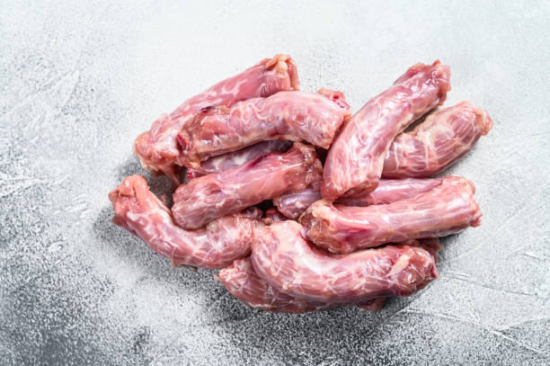 istock Raw fresh chicken neck meat. Gray background. Top view 1297159227