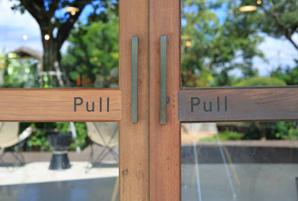 istock Glass door of restaurant with text pull on wood. 1297159414