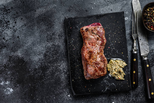 istock Grilled machete or skirt beef steak. Black background. Top view. Copy space 1297159816