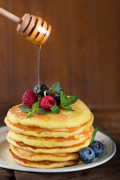 istock Stack of pancakes with fresh berries, close-up 1297160693