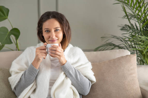 istock Serene young woman enjoying hot coffee at home 1297162103