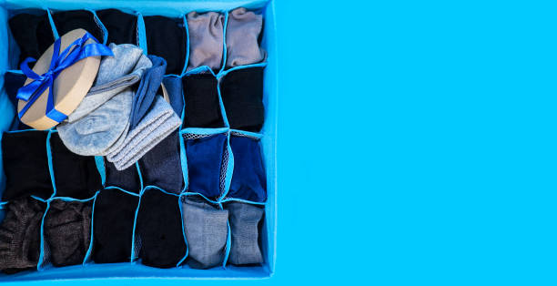 istock Men's multicolored socks stacked in packaging on a blue background. Gift set. 1297162542