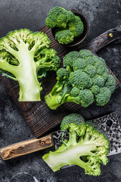 istock Sliced organic Raw green broccoli cabbage. Black background. Top view 1297164342