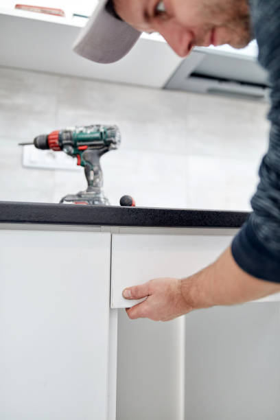 istock Handyman worker assembling furniture and fixing it. 1297164416