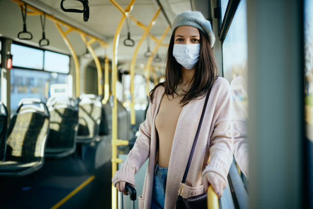 istock Young woman wearing protective face mask while commuting by public transport. 1297165860