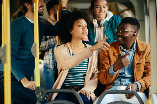 istock Happy black couple talking and pointing through the window while commuting by bus. 1297166216
