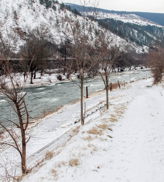 istock Scenic view on winter landscape with river bed 1297166469