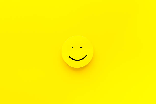 istock Smiling face emotion concept. Smile face on paper banner, top view 1297167291