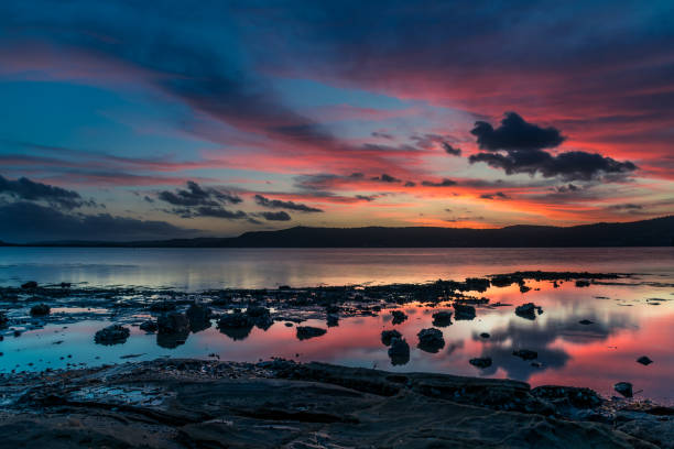 istock High cloud sunset waterscape with reflections by the bay 1297167295