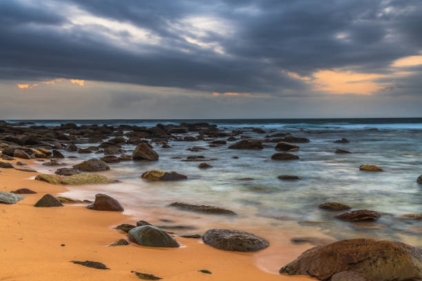 istock Sunrise at the seaside with rain clouds rolling in 1297167481