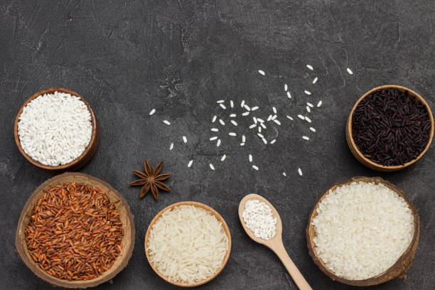 istock Different types of rice in wooden bowls. 1297169542