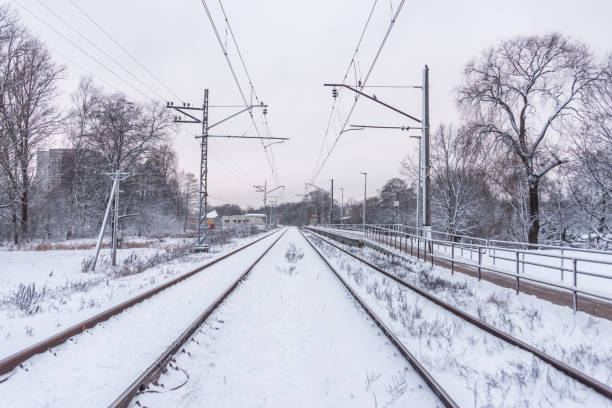 istock Electric Train Tracks Covered With Snow in Mid Winter 1297169606