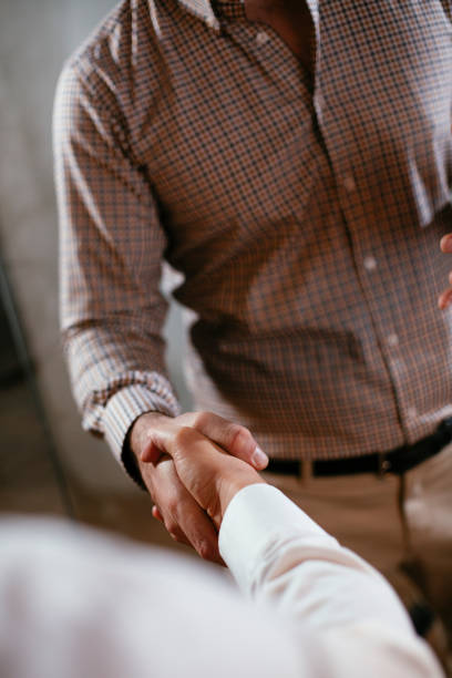 istock Close up of men handshake in office. 1297169701