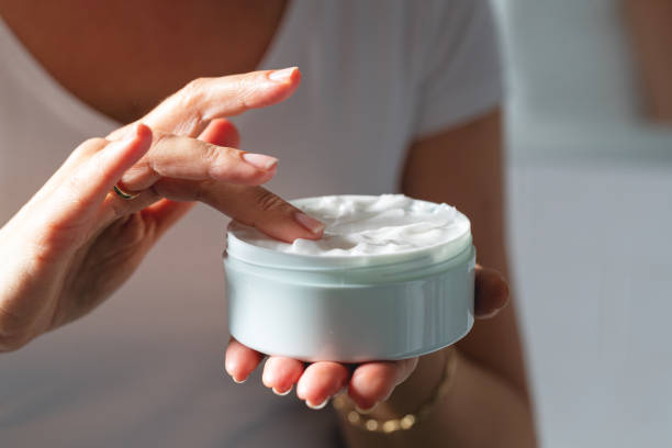 istock Unrecognizable woman using moisturizing cream for clean and soft skin 1297171214