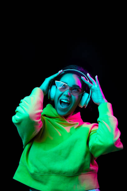 istock African-american woman's portrait isolated on dark studio background in multicolored neon light 1297171651