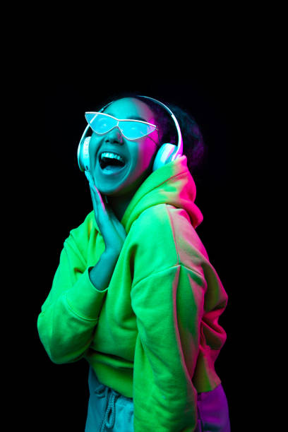 African-american woman's portrait isolated on dark studio background in multicolored neon light