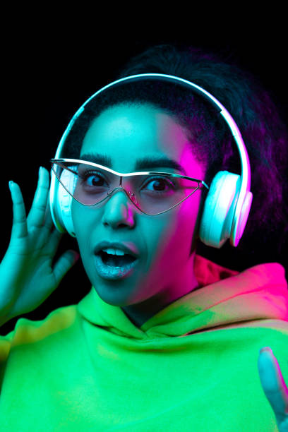 istock African-american woman's portrait isolated on dark studio background in multicolored neon light 1297171663
