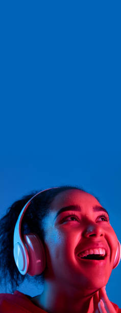 istock African-american woman's portrait isolated on blue studio background in multicolored neon light 1297171931