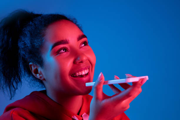 istock African-american woman's portrait isolated on blue studio background in multicolored neon light 1297171948