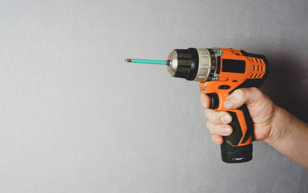 istock a man's hand holds an electric drill 1297173005