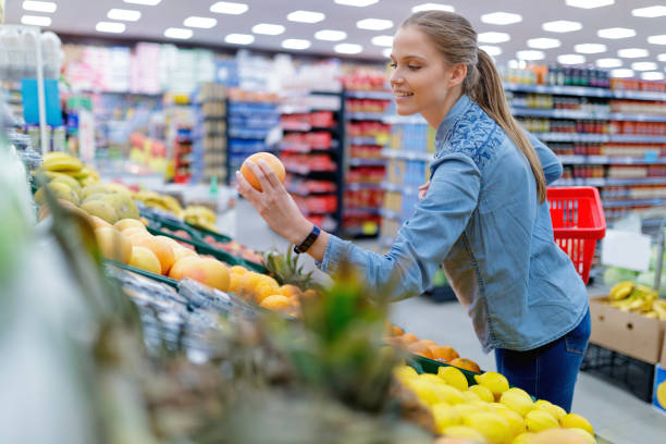 istock Customer picking up red grapefruit in local market 1297174072