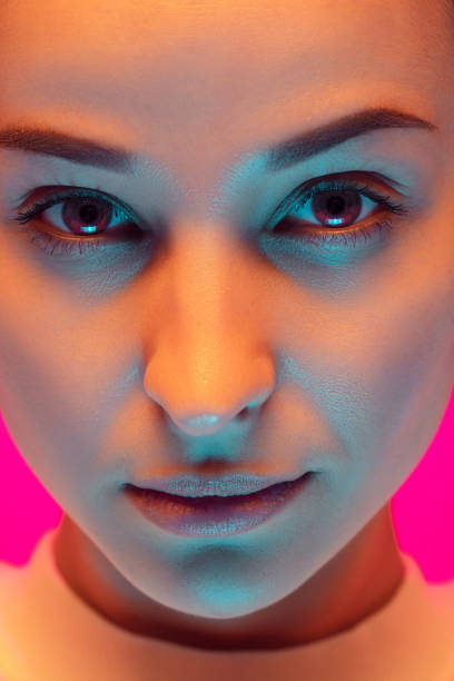 istock Caucasian beautiful woman's portrait isolated on pink studio background in multicolored neon light 1297174842