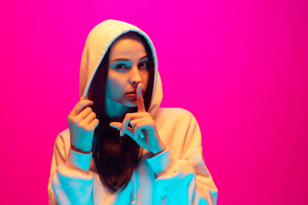 istock Caucasian beautiful woman's portrait isolated on pink studio background in multicolored neon light 1297174861