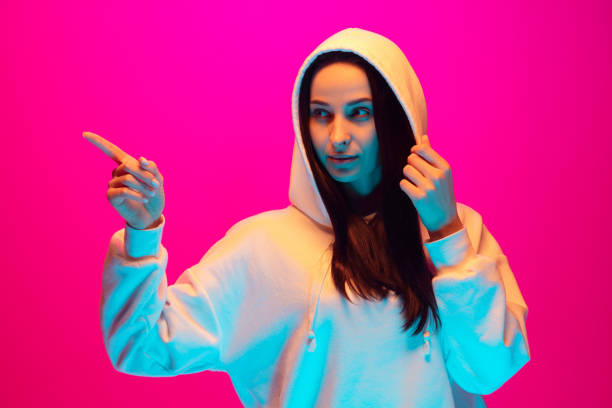istock Caucasian beautiful woman's portrait isolated on pink studio background in multicolored neon light 1297174868