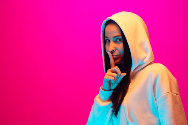 istock Caucasian beautiful woman's portrait isolated on pink studio background in multicolored neon light 1297174872