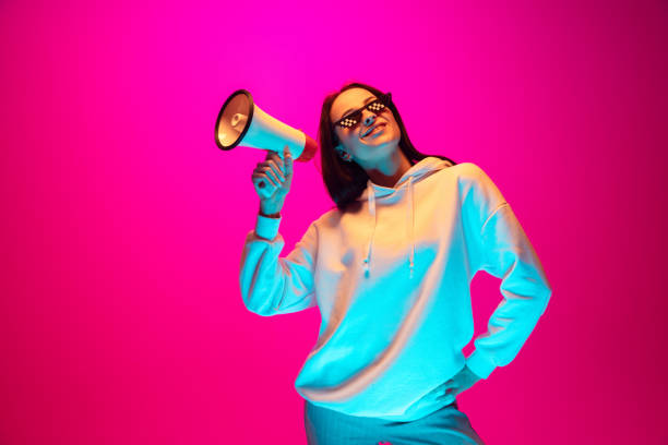 istock Caucasian beautiful woman's portrait isolated on pink studio background in multicolored neon light 1297174895