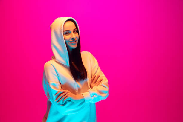 istock Caucasian beautiful woman's portrait isolated on pink studio background in multicolored neon light 1297174914
