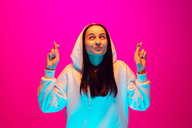 istock Caucasian beautiful woman's portrait isolated on pink studio background in multicolored neon light 1297174917