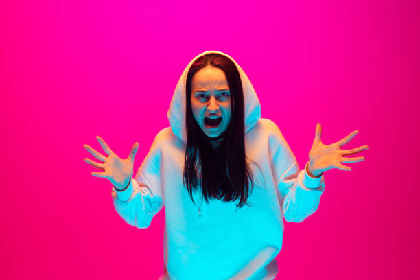 istock Caucasian beautiful woman's portrait isolated on pink studio background in multicolored neon light 1297174929