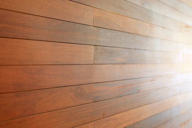 istock Perspective Brown wood plank wall background with ray of light. 1297176058