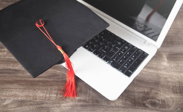 istock Graduation hat and laptop. Online Education 1297176436